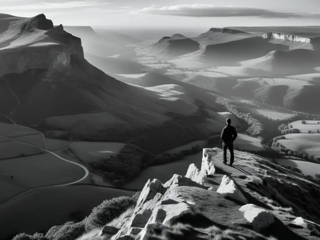 Figura solitaria en un acantilado, contemplando un valle cubierto por la niebla