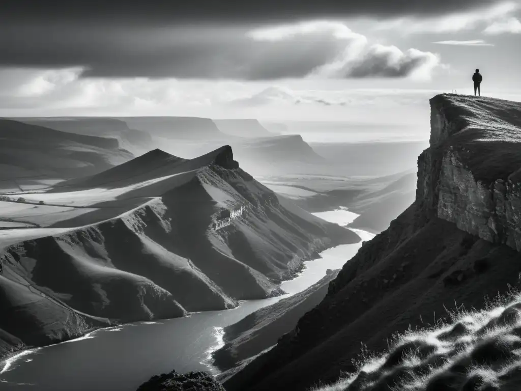 Un solitario contempla el horizonte desde un acantilado, envuelto en la vastedad del paisaje